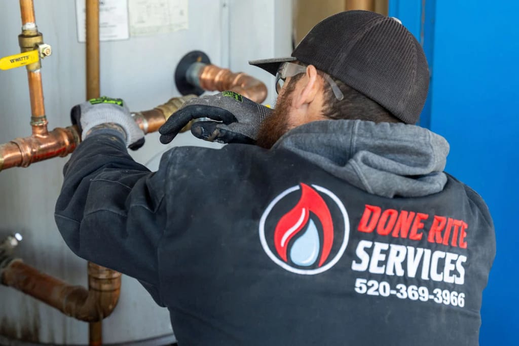 Done Rite Services expert plumber working on copper pipe for water heater repair in Tucson