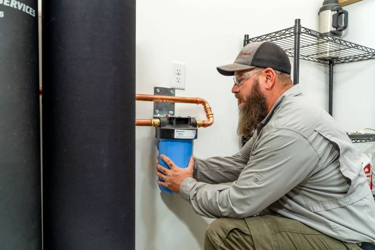 Done Rite professional plumber working on water softener installation in Tucson