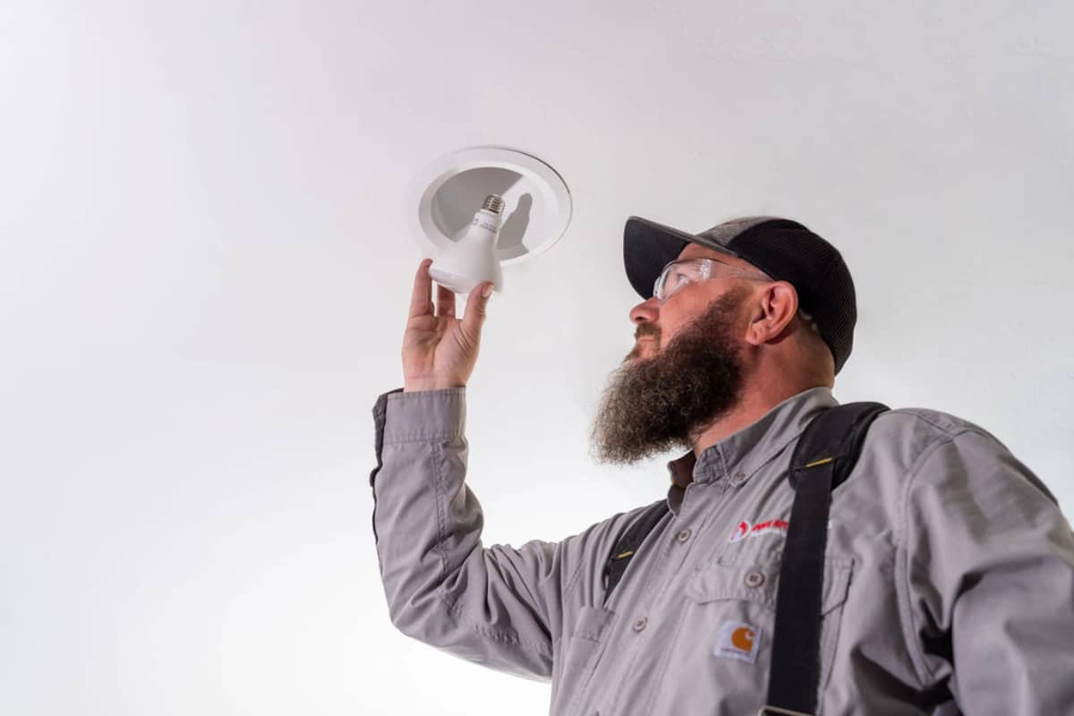 Image of Done Rite electrician in Tucson installing lightbulb