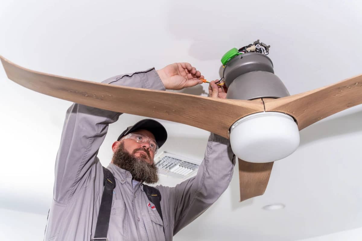 Done Rite technician installing ceiling fan in Tucson