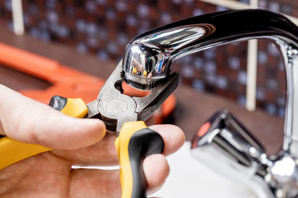 Professional Done Rite Services plumber in Tucson repairing a leaky faucet with precision tools.