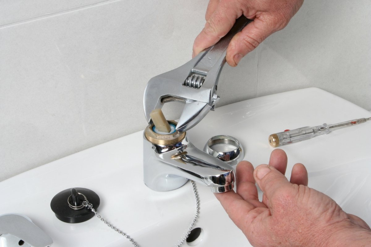 Tucson bathroom faucet receiving professional repair service from Done Rite Services to eliminate dripping.