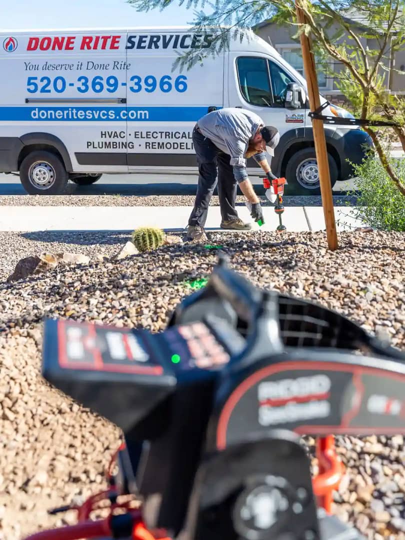 Done Rite Services expert plumber with Done Rite van working on Sewer line repair in Tucson