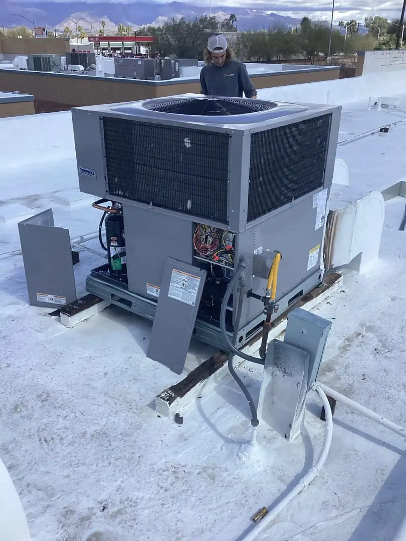 Done Rite Services HVAC technician executing a precision gas system installation on a commercial building's rooftop, optimizing space and efficiency.
